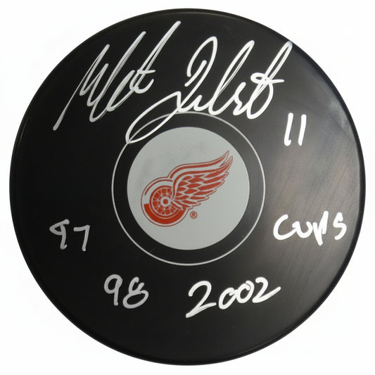 Mathieu Dandenault Autographed Detroit Red Wings Puck, With "97, 98, 2002 Cups" And Beckett COA